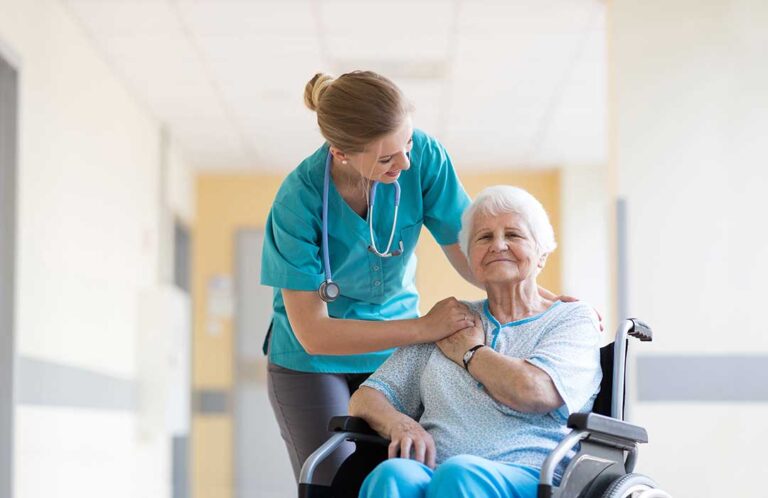 Older adults boarding an accessible van with walkers while a caregiver provides assistance.