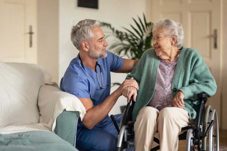 Older adults participate in a calm morning activity while a caregiver checks a daily schedule.